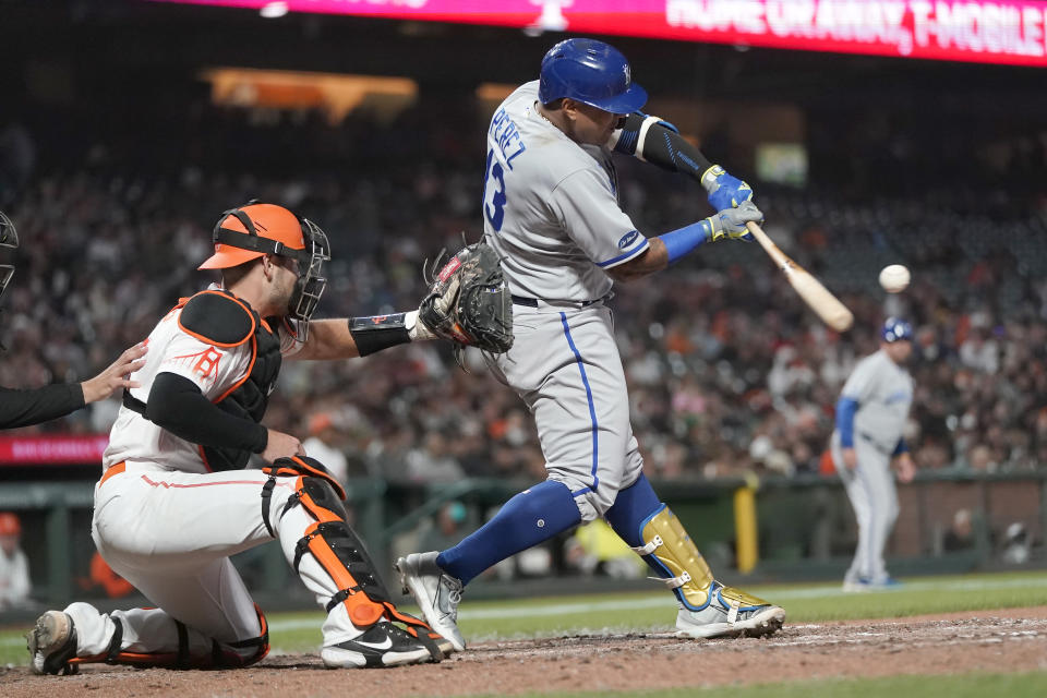 Kansas City Royals' Salvador Perez hits an RBI single in front of San Francisco Giants catcher Austin Wynns during the eighth inning of a baseball game in San Francisco, Tuesday, June 14, 2022. (AP Photo/Jeff Chiu)