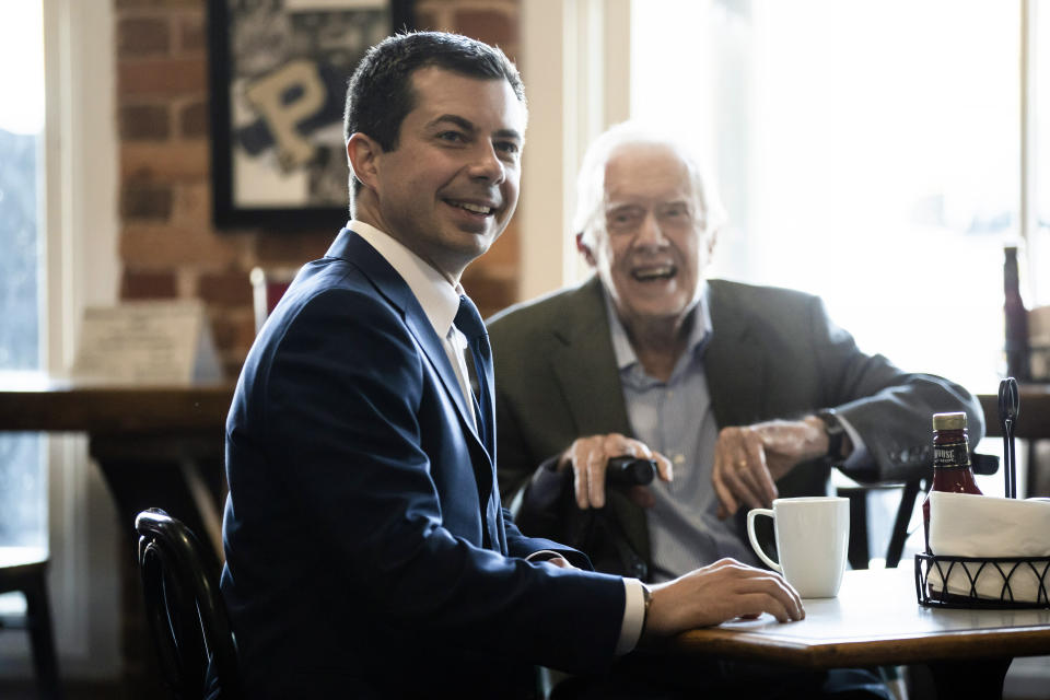 Democratic presidential candidate and former South Bend, Ind. Mayor Pete Buttigieg, left, meets with former President Jimmy Carter at the Buffalo Cafe in Plains, Ga., Sunday, March 1, 2020. (AP Photo/Matt Rourke)