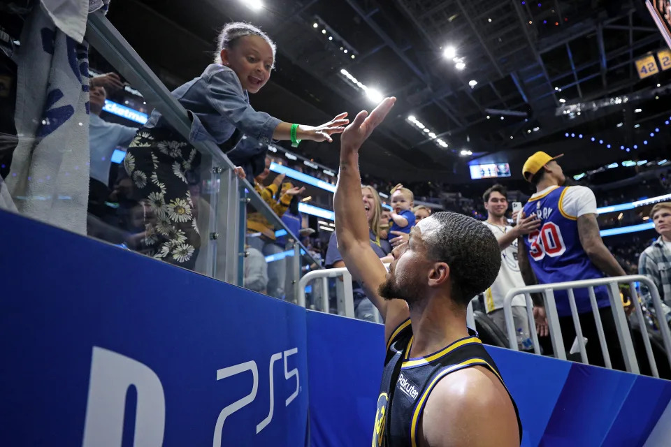 <p>High fives and good vibes! Stephen singled out Ryan in the crowd after the Warriors beat the Denver Nuggets in game five of the Western Conference First Round NBA Playoffs in April 2022.</p>