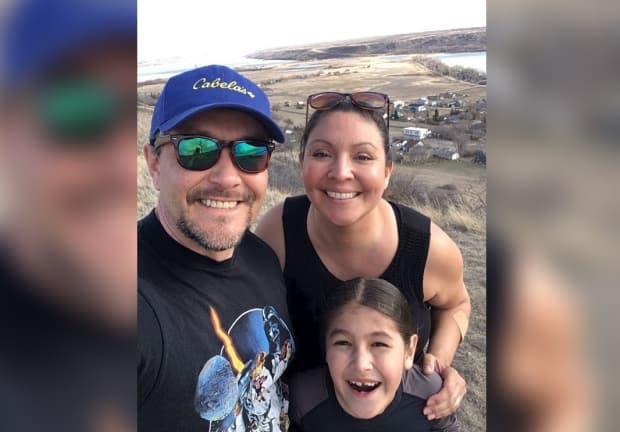 Philip and Michelle Brass (pictured with son Forrest) each set a goal of climbing the Lebret hill 200 times in one year. (Submitted by Philip and Michelle Brass - image credit)