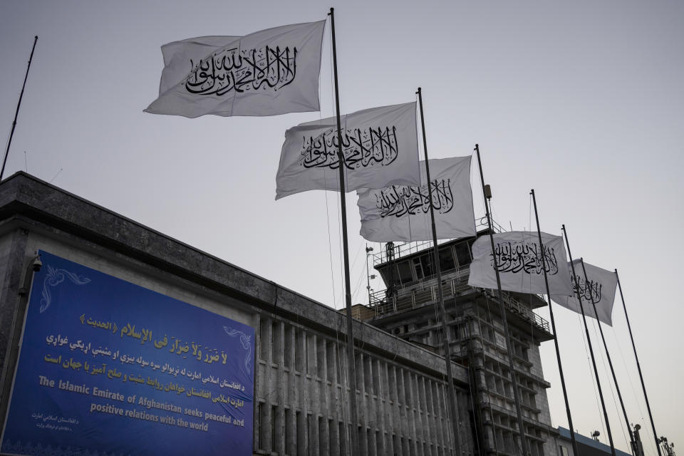 FILE - Taliban flags fly at the airport in Kabul, Afghanistan, Sept. 9, 2021. The Taliban announced a deal Tuesday, May 24, 2022, allowing the Abu Dhabi-based firm GAAC Solutions to manage the airports in Herat, Kabul and Kandahar. However, the United Arab Emirates did not immediately acknowledge the deal. (AP Photo/Bernat Armangue, File)