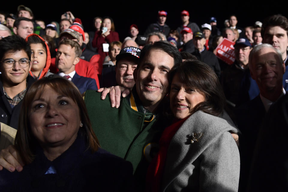 Wisconsin Gov. Scott Walker, center, hugs Republican Senate candidate Leah Vukmir, right, during a rally with President Donald Trump at Central Wisconsin Airport in Mosinee, Wis., Wednesday, Oct. 24, 2018. (AP Photo/Susan Walsh)
