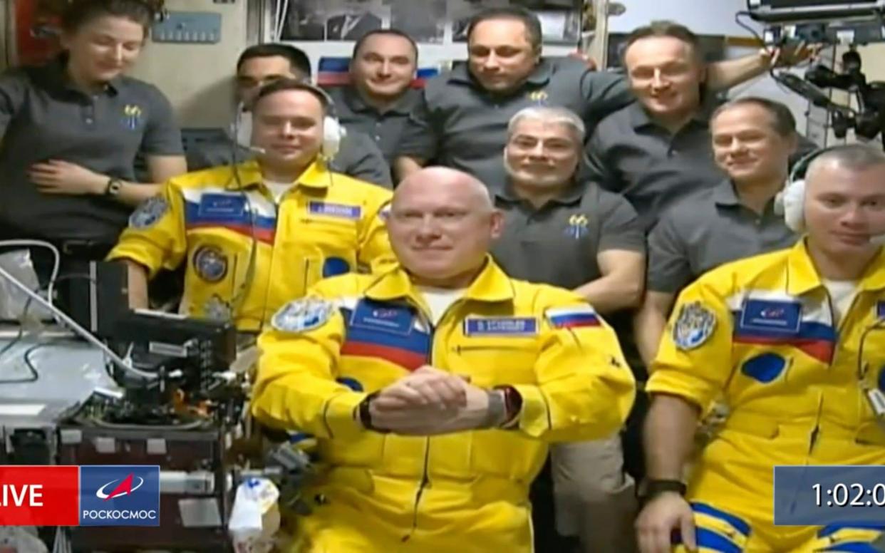 Russian cosmonauts arrive in space wearing colours of the Ukrainian flag - Roscosmos via AP