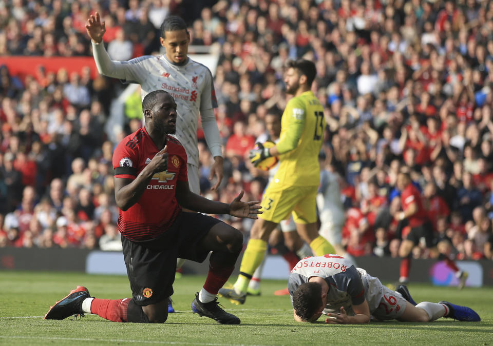 Manchester United's Romelu Lukaku, left, reacts after missing a scoring chance during the English Premier League soccer match between Manchester United and Liverpool at Old Trafford stadium in Manchester, England, Sunday, Feb. 24, 2019. (AP Photo/Jon Super)