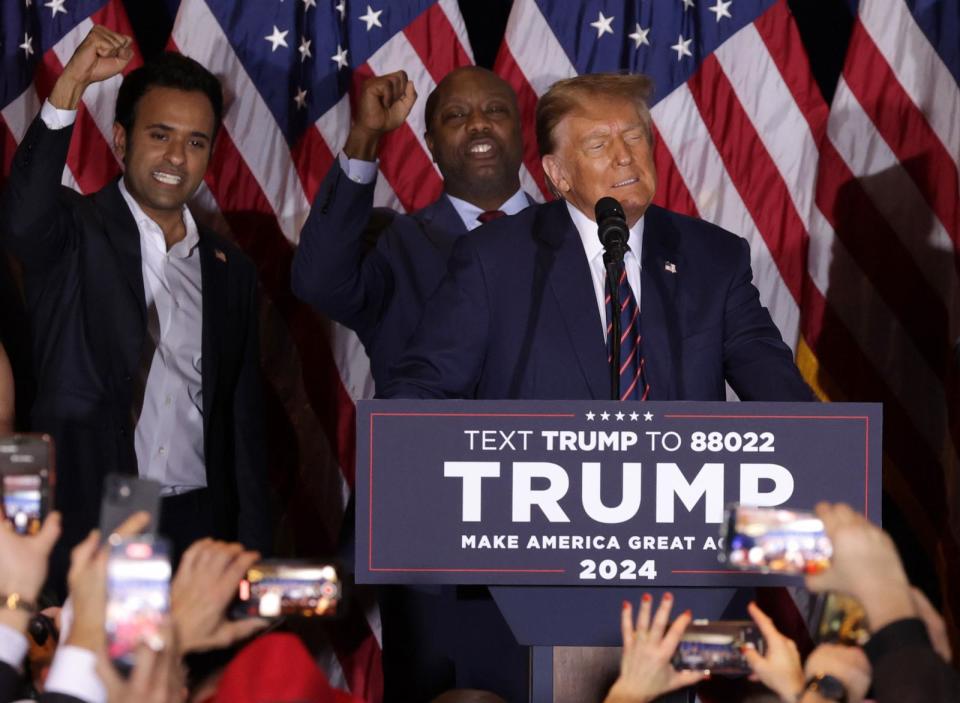 PHOTO: Republican presidential candidate and former President Donald Trump delivers remarks alongside Vivek Ramaswamy and Sen. Tim Scott during his primary night rally, Jan. 23, 2024 in Nashua, New Hampshire.  (Alex Wong/Getty Images)