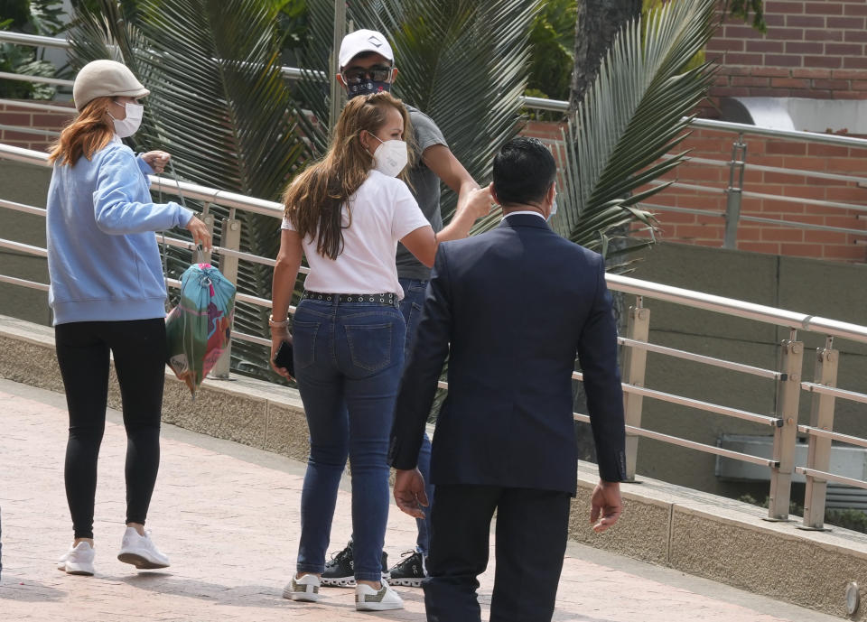 Flor Gomez, center, the mother of Colombian cyclist Egan Bernal, arrives at the hospital where her son was taken in Bogota, Colombia, Tuesday, Jan. 25, 2022. The 2019 champion of the Tour de France had an accident on Monday while training with teammates from the Ineos Grenadiers team. (AP Photo/Fernando Vergara)