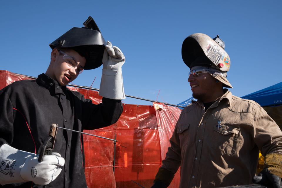 Hunter Bell (left), of Tonopah Valley High School, talks with Jesus Rodriguez from Arizona Pipe Trades Local 469, during Arizona Construction Career Days at the Arizona National Guard in Phoenix on Nov. 1, 2023.