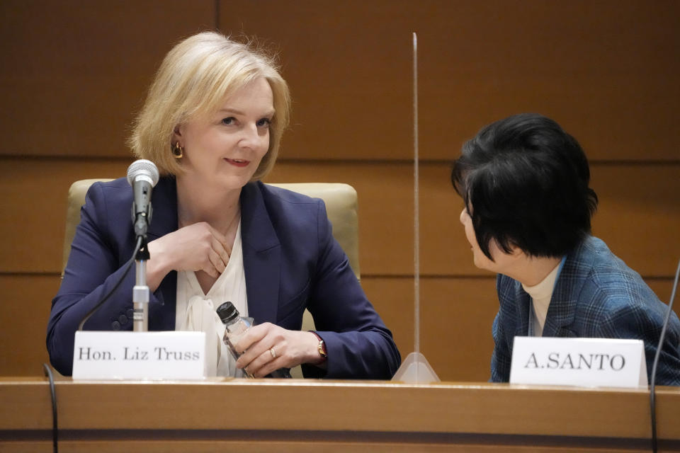 Former British Prime Minister Liz Truss, left, speaks with Akiko Santo, right, former President of the House of Councillors of Japan during a symposium of the Inter-Parliamentary Alliance on China at the Diet Members Building Friday, Feb. 17, 2023, in Tokyo. (AP Photo/Eugene Hoshiko)