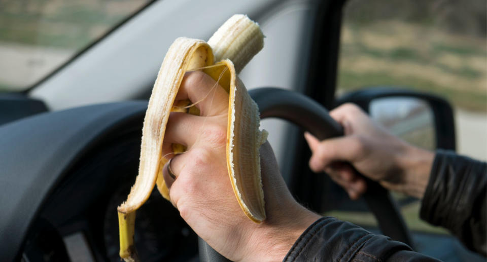 Eating behind the wheel is technically legal. Source: Getty, file.