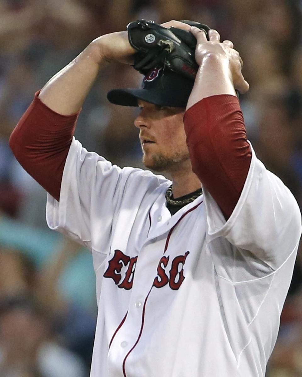 Boston Red Sox starting pitcher Jon Lester reacts as center fielder Brock Holt makes a difficult catch of a fly out by Minnesota Twins&#39; Brian Dozier which was momentarily lost in the outfield lights during the third inning of a baseball game at Fenway Park in Boston, Tuesday, June 17, 2014. (AP Photo/Elise Amendola)