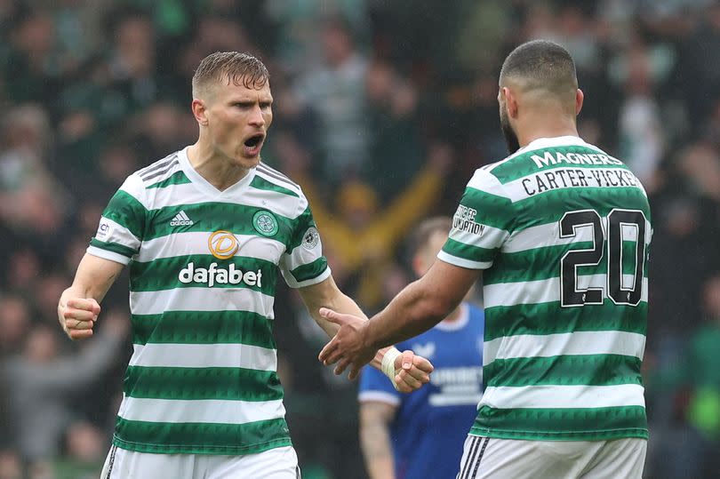 Carl Starfelt of Celtic embraces teammate Cameron Carter-Vickers