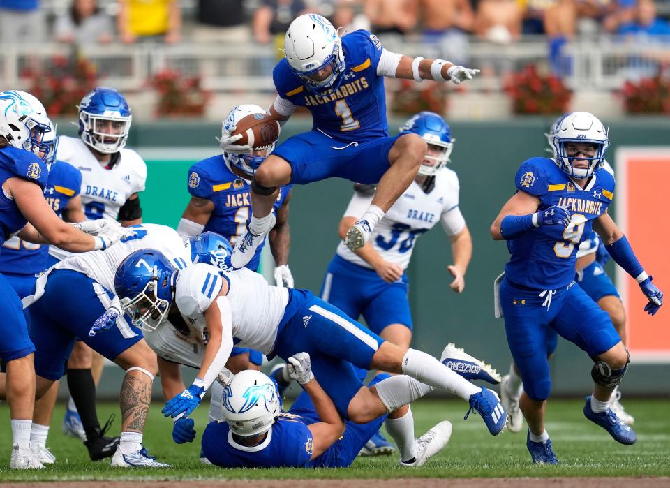 South Dakota State wide receiver Jadon Janke (1) hurdles Drake linebacker J.R. Flood (7) during the first half of an NCAA college football game Saturday, Sept. 16, 2023, in Minneapolis. (AP Photo/Abbie Parr)