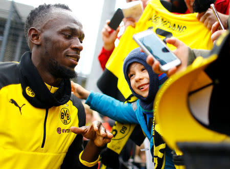 Soccer Football - Usain Bolt participates in a training session with Borussia Dortmund - Strobelallee Training Centre, Dortmund, Germany - March 23, 2018 Usain Bolt with fans after Borussia Dortmund training REUTERS/Thilo Schmuelgen