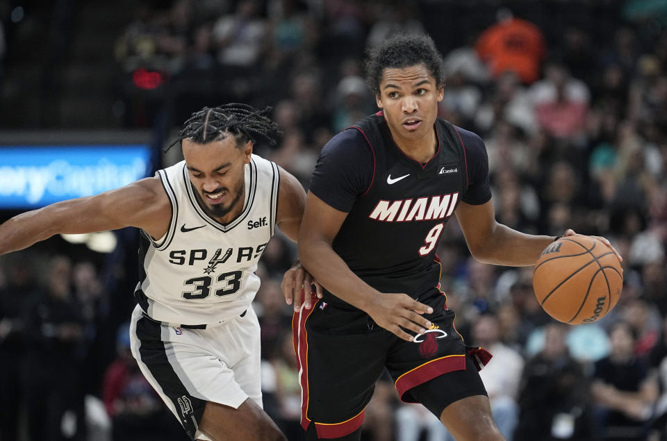 Miami Heat guard Dru Smith (9) drives against San Antonio Spurs guard Tre Jones (33) during the first half of a preseason NBA basketball game in San Antonio, Friday, Oct. 13, 2023. (AP Photo/Eric Gay)