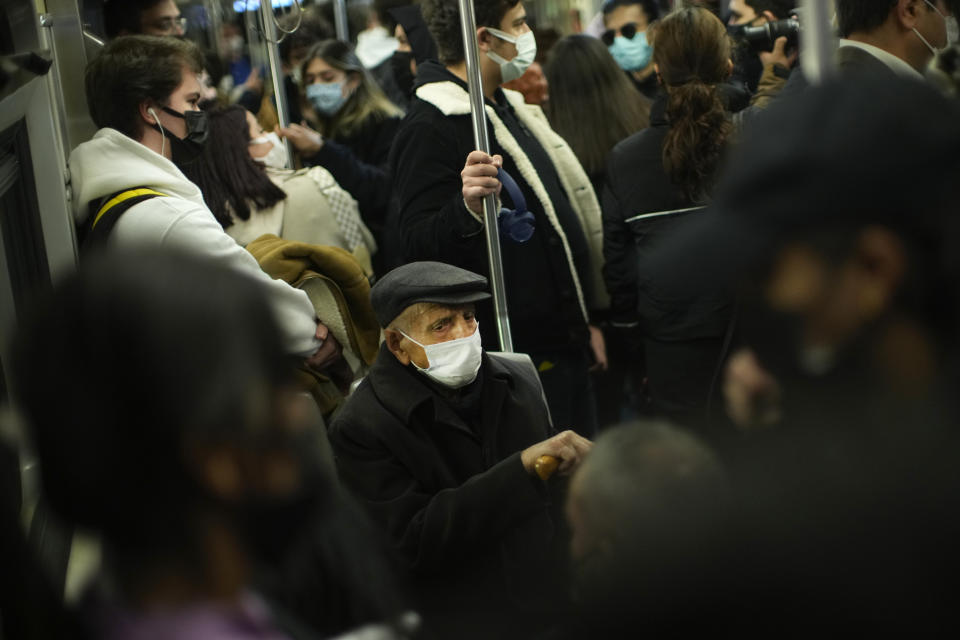 People, all wearing masks to prevent the spread of the COVID-19, take a ride in a metro in Istanbul, Turkey, Thursday, Dec. 2, 2021. The coronavirus's omicron variant kept a jittery world off-kilter Wednesday, as reports of infections linked to the mutant strain cropped up in more parts of the globe, and one official said that the wait for more information on its dangers felt like "an eternity". (AP Photo/Francisco Seco)