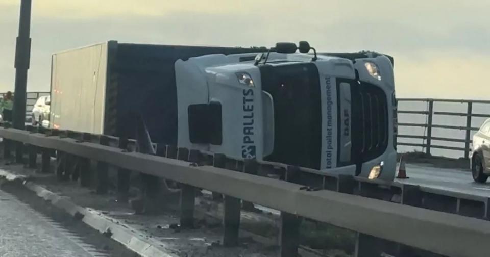 Gusty winds left a lorry blown over at Barton Bridge on the M60 in the north west. (Reach)