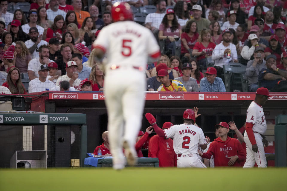 Los Angeles Angels' Luis Rengifo (2) returns to the dugout after scoring a run on a groundout by designated hitter Willie Calhoun (5) against the Detroit Tigers during the third inning of a baseball game in Anaheim, Calif., Saturday, June 29, 2024. (AP Photo/Eric Thayer)