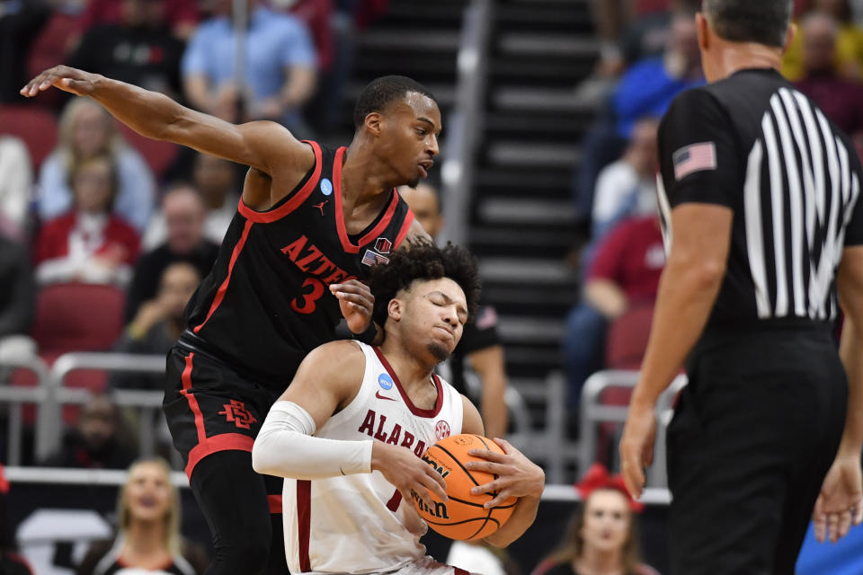 Alabama guard Mark Sears (1) and San Diego State guard Micah Parrish (3) collide in the first half of a Sweet 16 round college basketball game in the South Regional of the NCAA Tournament, Friday, March 24, 2023, in Louisville, Ky. (AP Photo/Timothy D. Easley)