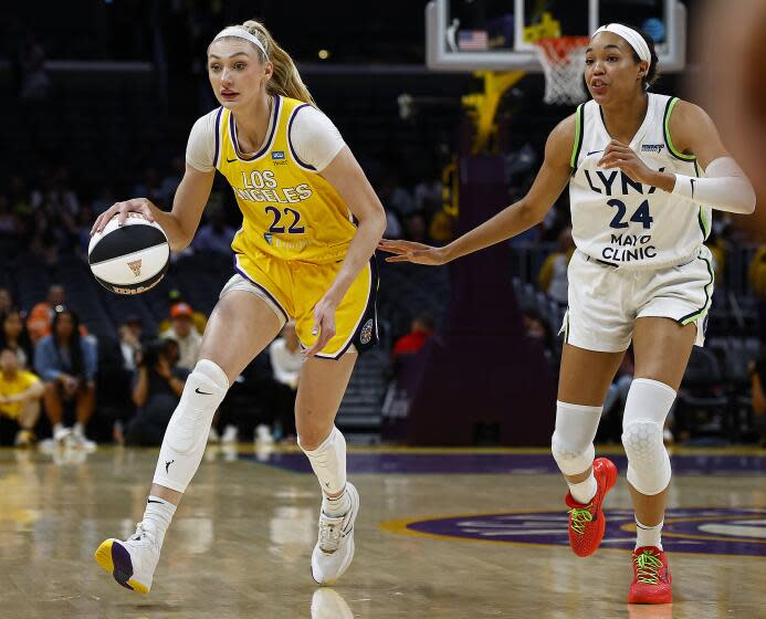 Lakers center Cameron Brink controls the ball in front of te Minnesota Lynx's Napheesa Collier