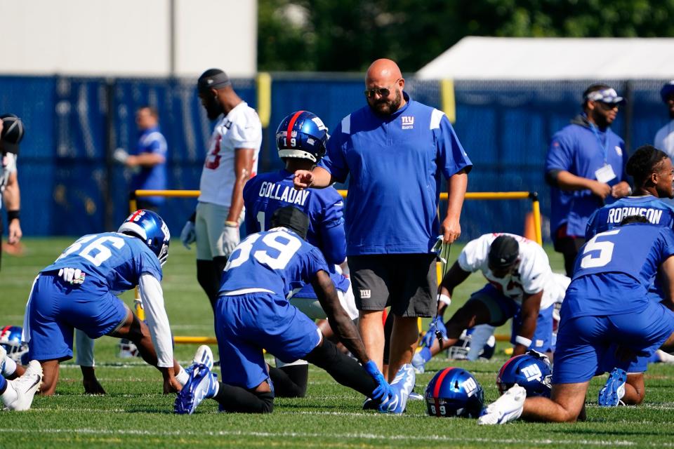 New York Giants head coach Brian Daboll talks to wide receiver Kadarius Toney (89) during stretches on the first day of training camp at Quest Diagnostics Training Center in East Rutherford on Wednesday, July 27, 2022.