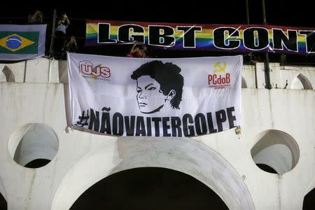 A banner with the image of Brazilian President Dilma Rousseff is displayed during a protest against her impeachment in Rio de Janeiro, Brazil, April 11, 2016. REUTERS/Pilar Olivares