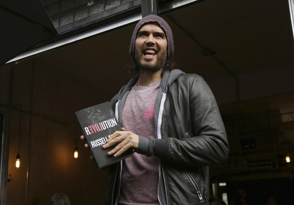 FILE - Russell Brand speaks at the opening of The Trew Era Cafe, a social enterprise community project on the New Era estate in east London, Thursday, 26 March, 2015. Three British news organizations are on Saturday, Sept. 16, 2023 reporting that comedian and social influencer Russell Brand has been accused of rape, sexual assault and abuse based on allegations from four women who knew him over a seven-year period at the height of his fame. (Photo by Joel Ryan/Invision/AP, file)