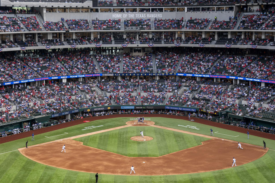 Fans fill the stands at Globe Life Field during the second inning of a baseball game between the Texas Rangers and the Toronto Blue Jays, Monday, April 5, 2021, in Arlington, Texas. The Rangers are set to have the closest thing to a full stadium in pro sports since the coronavirus shutdown more than a year ago. (AP Photo/Jeffrey McWhorter)