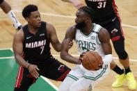 Miami Heat's Kyle Lowry, left, defends against Boston Celtics' Jaylen Brown during the first half of Game 3 of the NBA basketball playoffs Eastern Conference finals Saturday, May 21, 2022, in Boston. (AP Photo/Michael Dwyer)