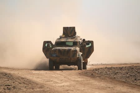 FILE PHOTO - Syrian Democratic Forces(SDF) fighters ride a military vehicle north of Raqqa city, Syria March 8, 2017. REUTERS/Rodi Said