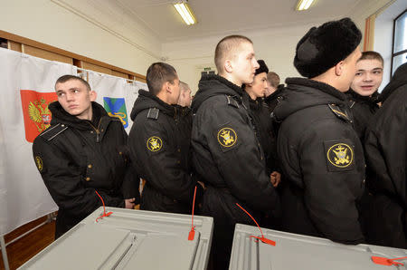 Sailors queue to vote during the presidential election at a polling station in the far eastern city of Vladivostok, Russia March 18, 2018. REUTERS/Yuri Maltsev