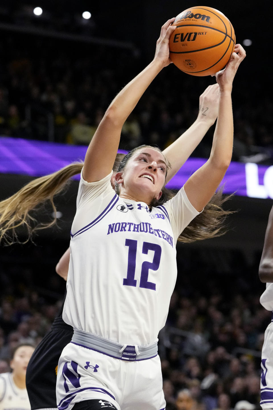 Northwestern guard Casey Harter rebounds the ball against Iowa center Sharon Goodman during the first half of an NCAA college basketball game in Evanston, Ill., Wednesday, Jan. 31, 2024. Iowa won 110-74. (AP Photo/Nam Y. Huh)