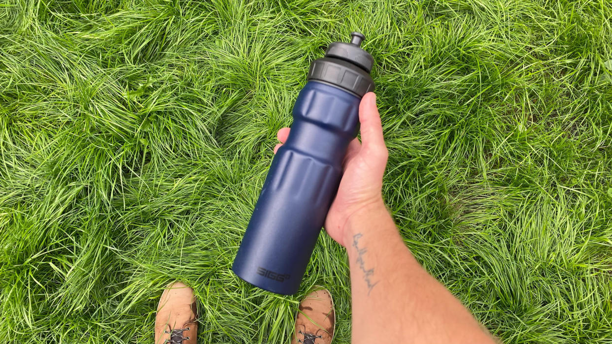  Man carrying a water bottle hiking 