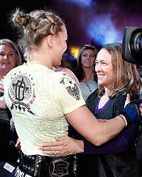 Ronda Rousey (L) hugs her mom after winning the Strikeforce bantamweight title belt from Miesha Tate