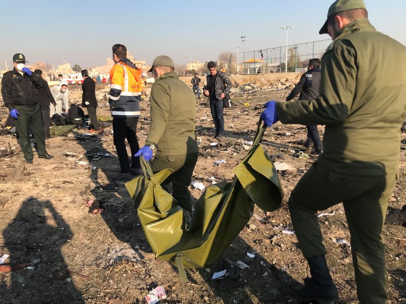 Rescue team members check the debris from a plane crash belonging to Ukraine International Airlines after take-off from Iran's Imam Khomeini airport, on the outskirts of Tehran