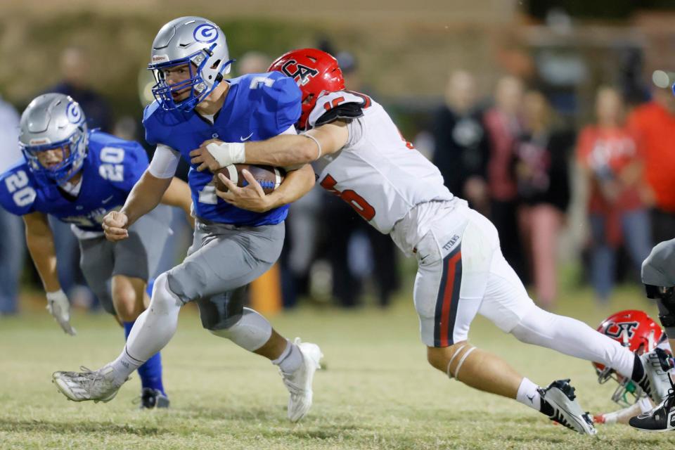 Guthrie's Hayden Calvert is brought down by Carl Albert's Caden Davis during a high school football game between Guthrie and Carl Albert in Guthrie, Okla., Thursday, Oct. 19, 2023.