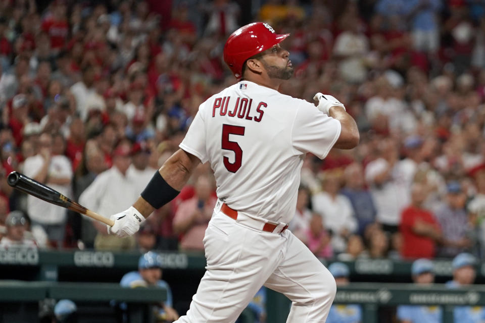 St. Louis Cardinals' Albert Pujols follows through on an RBI single during the first inning of a baseball game against the Milwaukee Brewers Tuesday, Sept. 13, 2022, in St. Louis. (AP Photo/Jeff Roberson)