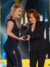 <p>Lauren Alaina accepts an award onstage from Reba McEntire at the 2017 CMT Music Awards at the Music City Center on June 7, 2017 in Nashville, Tennessee. (Photo by Kevin Mazur/WireImage) </p>