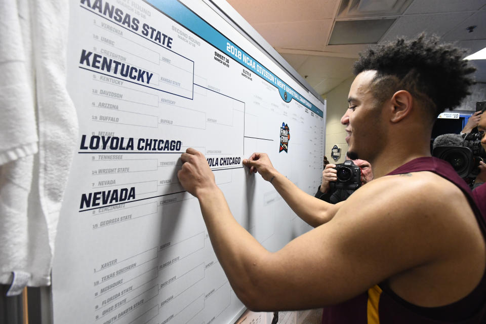<p>Marques Townes #5 of the Loyola Chicago Ramblers puts the team name advancing to the Elite 8 the third round of the 2018 NCAA Men’s Basketball Tournament held at Philips Arena on March 22, 2018 in Atlanta, Georgia. (Photo by Brett Wilhelm/NCAA Photos via Getty Images) </p>