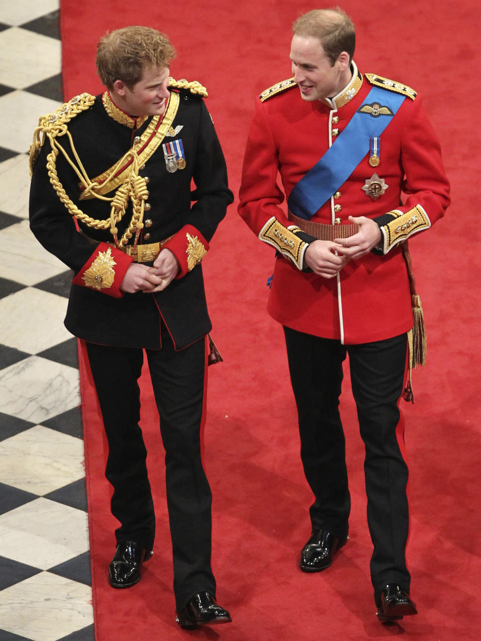 FILE - Britain's Prince Harry, left, best man to Britain's Prince William, right, arrive ahead of Prince William's marriage to Kate Middleton at Westminster Abbey, London, April 29, 2011. Prince Harry’s explosive memoir, with its damning allegations of a toxic relationship between the monarchy and the press, is likely to accelerate the pace of change already under way within the House of Windsor following the death of Queen Elizabeth II. (AP Photo/Andrew Milligan, Pool, File)