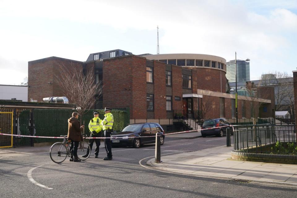 Police at the scene of a shooting outside a memorial service which was being held in St Aloysius Roman Catholic Church on Phoenix Road, in Euston (PA)