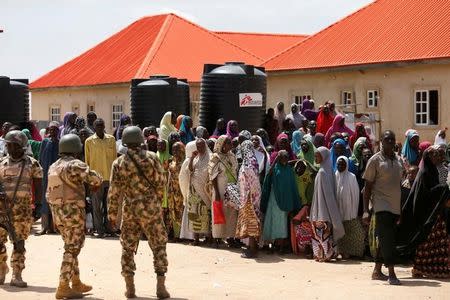 Security officers are seen at the Bakkasi camp for internally displaced people, after security was called to control some refugees, who rallied against camp authorities for what they say is poor distribution of food rations, in Borno, Nigeria, August 29, 2016. REUTERS/Afolabi Sotunde