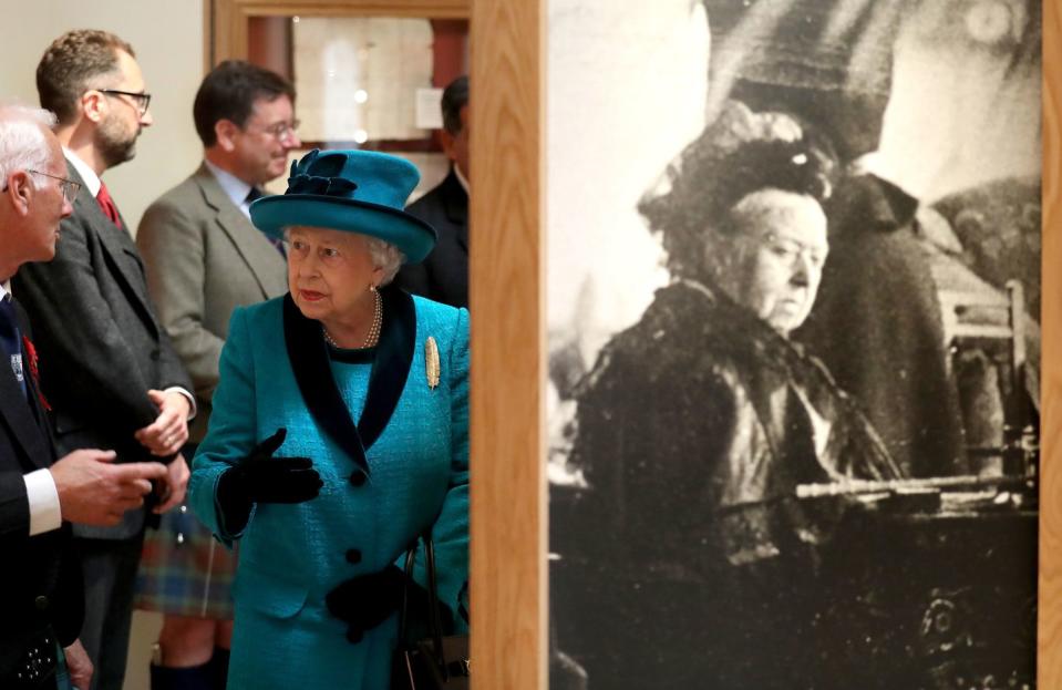 6) The Queen observes an exhibit in the Duke of Rothesay Highland Games Pavilion