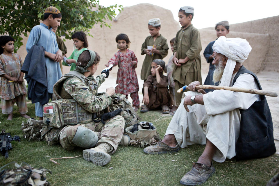 Campaign: Cpt Anna Crossley, a nurse at UCL Hospital, talks to Afghan youngsters on the tour (Alison Baskerville)