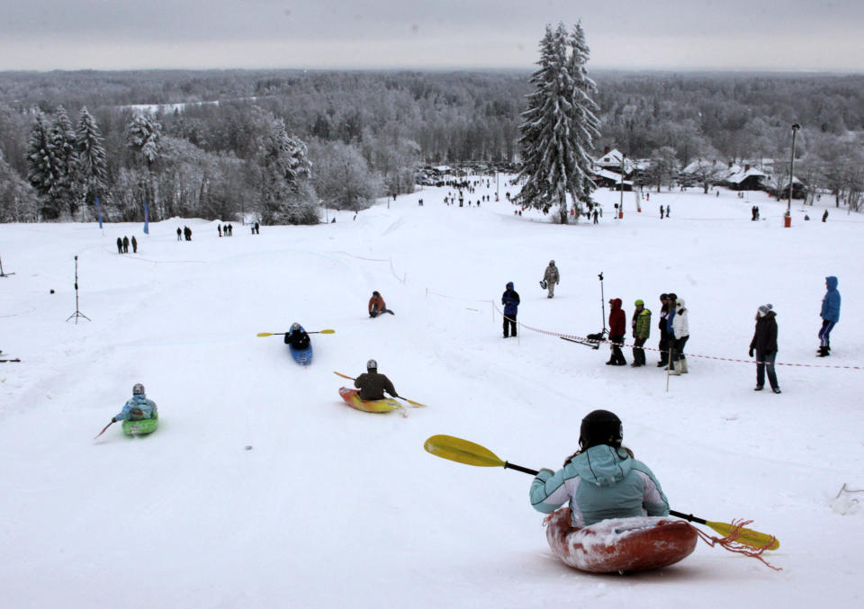 People compete during a snow kayak downhill race near Otepaa, January 26, 2013. REUTERS/Ints Kalnins (ESTONIA - Tags: SPORT SOCIETY TPX IMAGES OF THE DAY) - RTR3D036