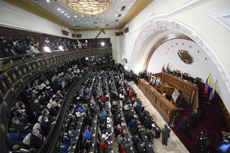 Incoming lawmakers members fill the chamber of the National Assembly during the year's first session in Caracas, Venezuela, Tuesday, Jan. 5, 2021. The ruling socialist party assumed the leadership of Venezuela's congress on Tuesday, the last institution in the country it didn't already control. (AP Photo/Matias Delacroix)