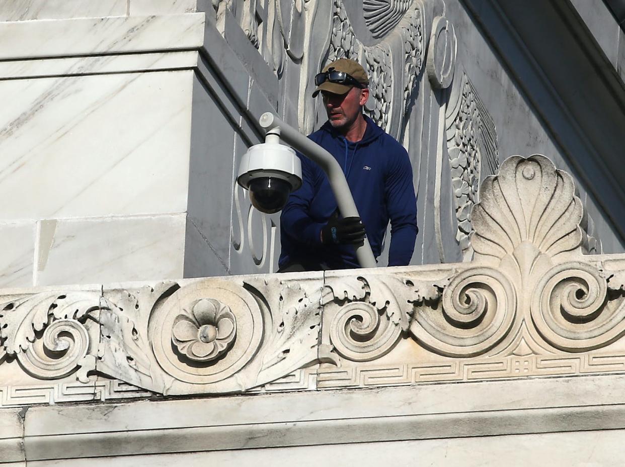 <span class="caption">Government agencies are increasingly using facial recognition technology, including through security cameras like this one being installed on the Lincoln Memorial in 2019.</span> <span class="attribution"><a class="link " href="https://www.gettyimages.com/detail/news-photo/technician-installs-a-security-camera-atop-of-the-lincoln-news-photo/1159591338" rel="nofollow noopener" target="_blank" data-ylk="slk:Mark Wilson/Getty Images;elm:context_link;itc:0;sec:content-canvas">Mark Wilson/Getty Images</a></span>