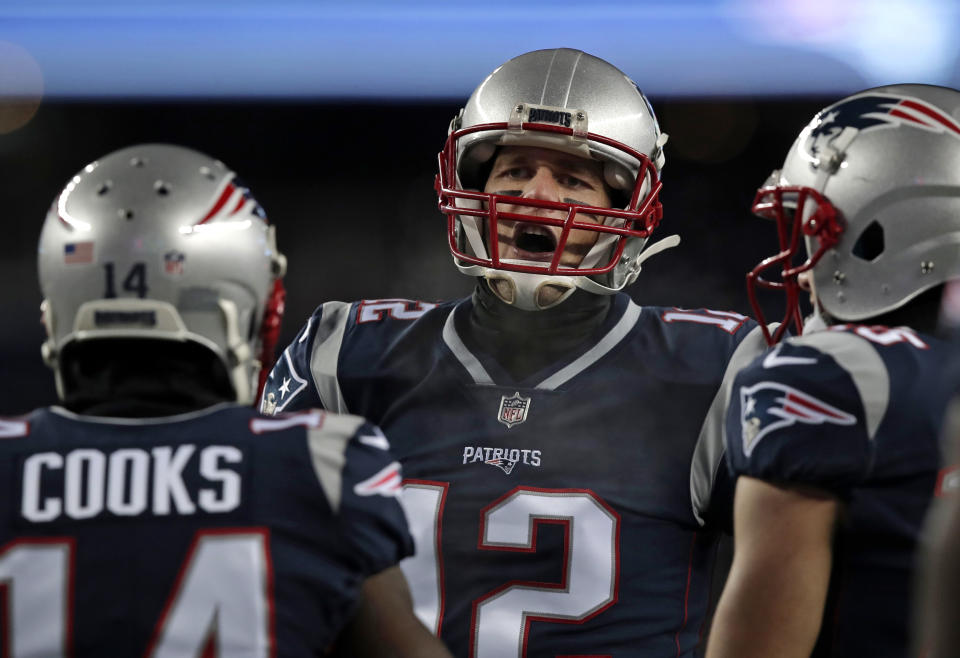 Tom Brady tossed three touchdown passes in the Patriots' playoff rout of the Titans on Saturday night. (AP) 