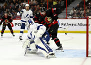 The puck bounces off the goalposts behind Tampa Bay Lightning goaltender Brian Elliott (1) and Ottawa Senators right wing Drake Batherson (19) during second-period NHL hockey game action in Ottawa, Thursday, March 23, 2023. (Justin Tang/The Canadian Press via AP)