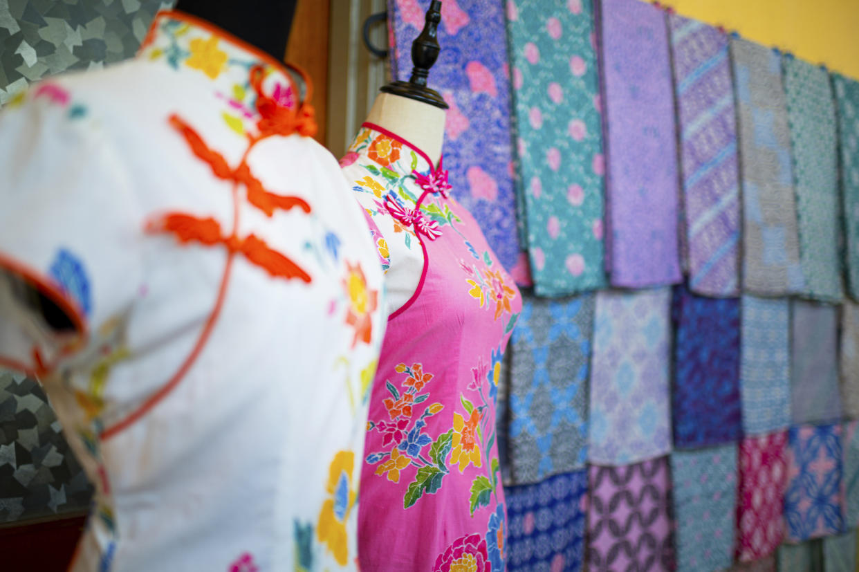 A white and pink cheongsam on a mannequin in a shop