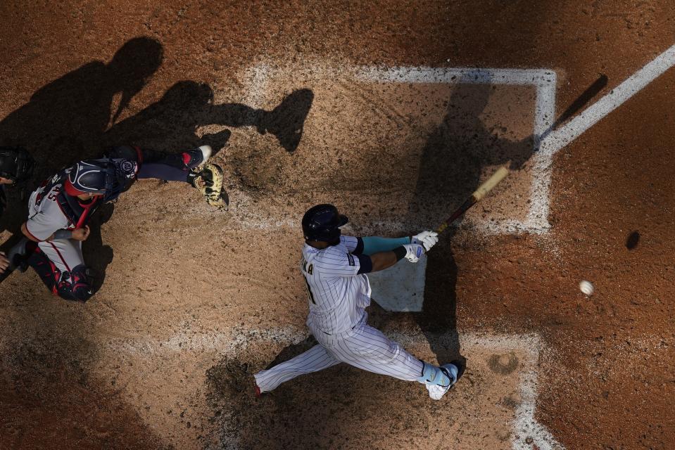 Milwaukee Brewers' Carlos Santana hits a single during the ninth inning of a baseball game against the Washington Nationals Sunday, Sept. 17, 2023, in Milwaukee. (AP Photo/